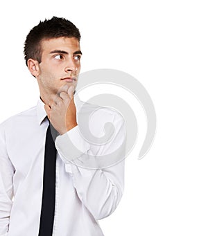 Thoughtful in his next decision. A business man looking to the side in deep thought with a white background.