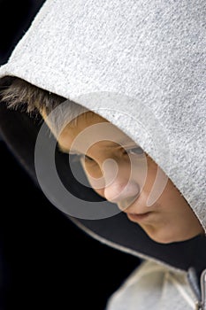 Thoughtful hooded teenage boy photo