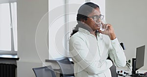 Thoughtful Indian businessman looking into distance thinking over project