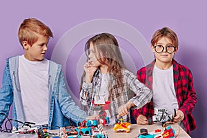 Thoughtful kids practive engineering together in studio