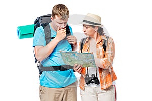 Thoughtful lost tourists looking at a map on a white