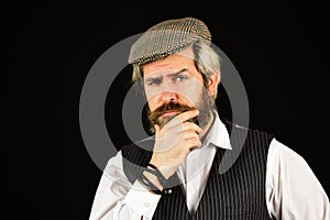 Thoughtful male vintage fashion. businessman farmer with dyed blonde beard. retro man in peaked cap. Portrait of mature