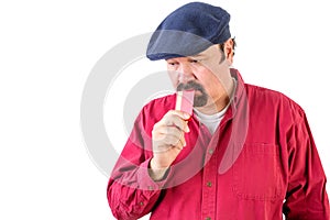 Thoughtful man holding a credit card as he ponders photo