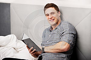 Thoughtful man with a note in his bed.