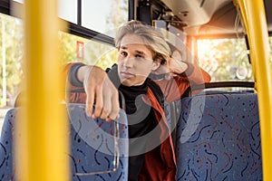 thoughtful man sitting on bus seat while riding