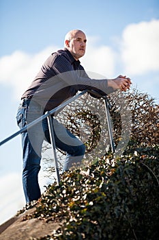 Thoughtful man sitting on a flight of steps