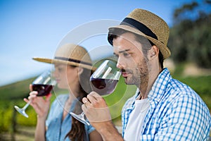 Thoughtful man smelling red wine in glass