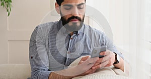 Thoughtful man using mobile phone