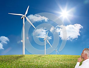 Thoughtful mature businessman looking at windmill