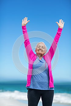 Thoughtful mature woman outstretching her arms