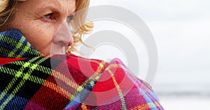 Thoughtful mature woman in shawl feeling cold