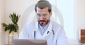 Thoughtful medical worker planning working schedule in computer application.