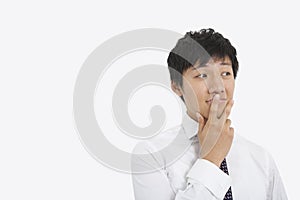 Thoughtful mid adult businessman over white background