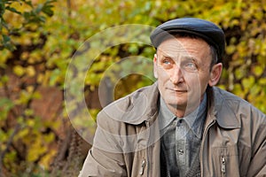 Thoughtful middleaged man in autumnal garden