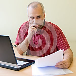 Thoughtful office worker photo