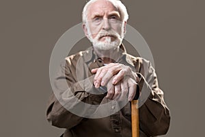 Thoughtful old man with walking stick