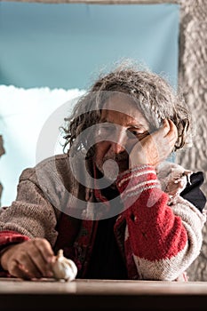 Thoughtful older man with tousled long hair