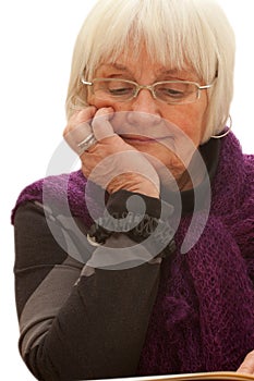 Thoughtful older woman reading a book