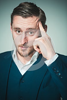 Thoughtful person. Man calm serious looking concentrated while touching head trying remember. Guy tense expression