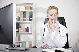 Thoughtful Physician with Index Finger on Lips