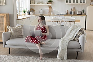 Thoughtful pretty student girl studying online at home