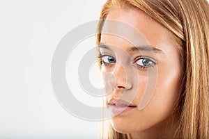 Thoughtful pretty young woman turning to camera