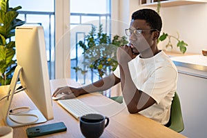 Thoughtful web developer work on computer, programmer trying to find solution for bug in app code