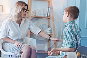 Thoughtful psychologist calming teenage patient