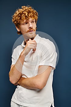 thoughtful redhead man in white stylish