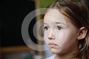 Thoughtful and sad little girl