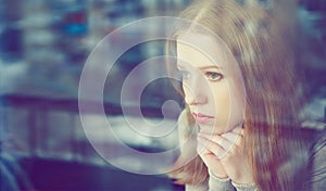 Thoughtful sadness girl is sad at window