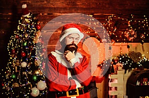 Thoughtful Santa claus. Winter holidays. Cozy home atmosphere. Winter decorations. Santa Claus bearded hipster serious