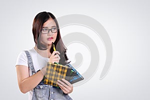 Thoughtful school girl looking at copy space on white