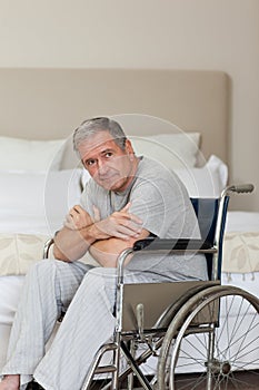 Thoughtful senior man in his wheelchair