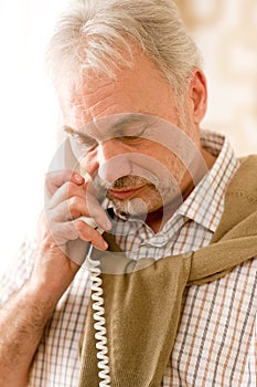 Thoughtful senior mature man call on phone