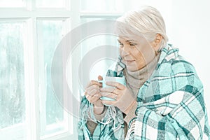 Thoughtful Senior Woman With A Cup Of Tea In Her Hand.