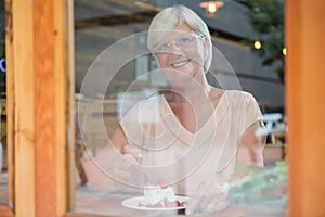 Thoughtful senior woman having breakfast