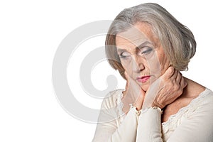 thoughtful senior woman isolated on white background