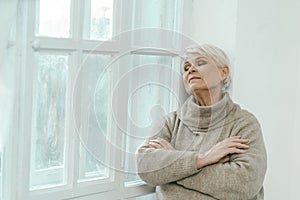 Thoughtful Senior Woman Looking At The Window