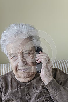 Thoughtful senior woman on phone