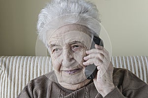 Thoughtful senior woman on phone