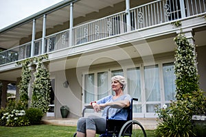 Thoughtful senior woman sitting on wheelchair