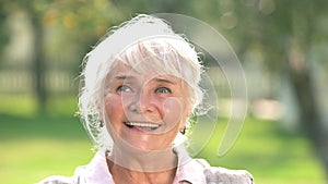 Thoughtful senior woman smiling.