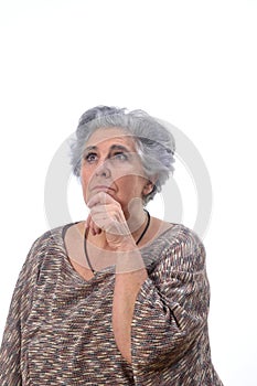 Thoughtful senior woman on white background