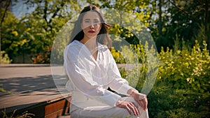 Thoughtful serious elegant dreaming caucasian woman businesswoman model posing in city park worried pensive frustrated