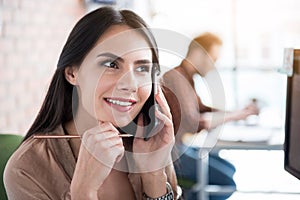 Thoughtful smiling woman keeping phone