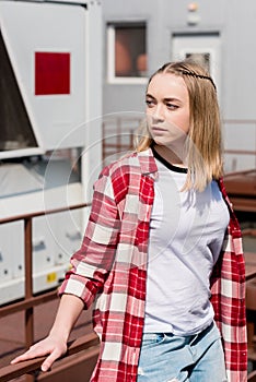 thoughtful teen girl in red plaid shirt