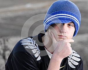 Thoughtful teenage boy with cap