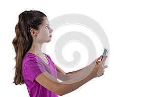 Thoughtful teenage girl holding digital tablet