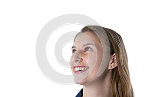 Thoughtful teenage girl smiling against white background